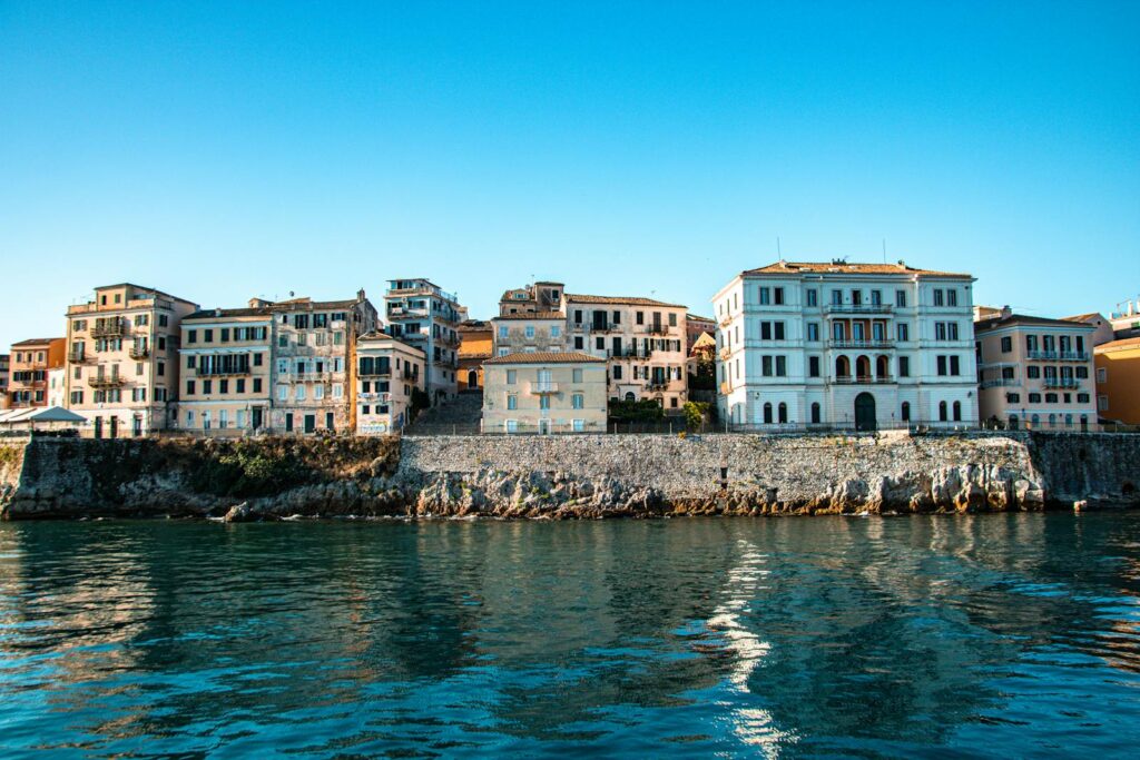 Stunning view of coastal buildings in Corfu, Greece under a clear blue sky.