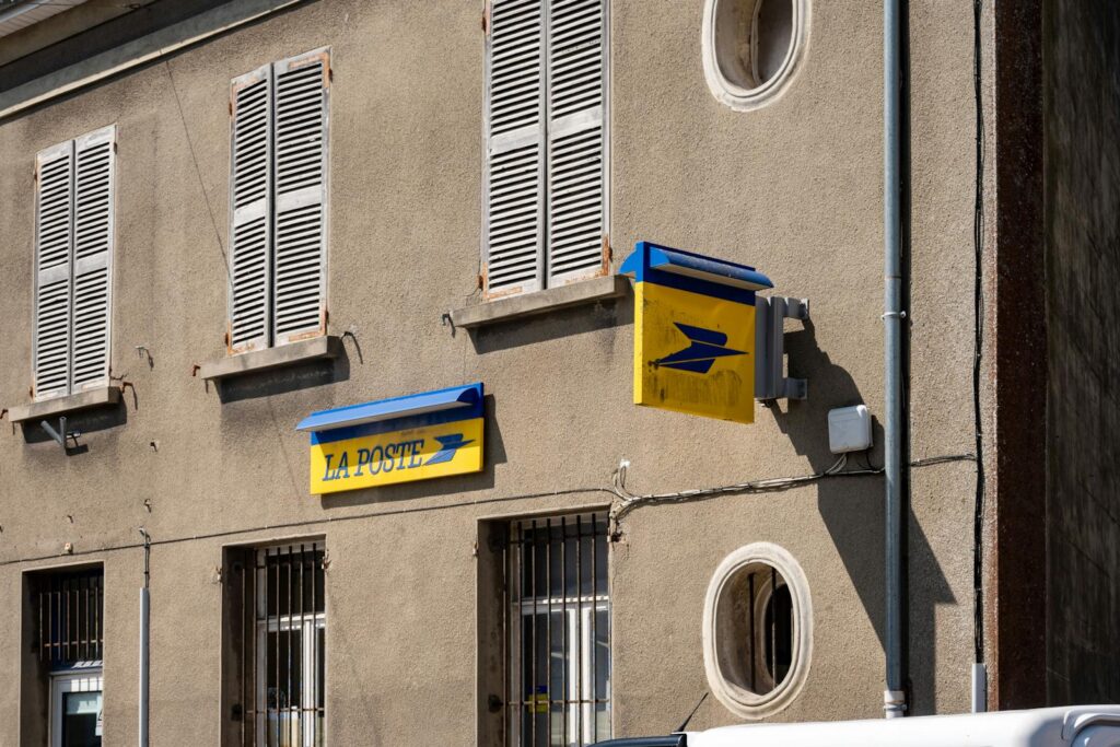 Street view of a La Poste building in France with its iconic signage.
