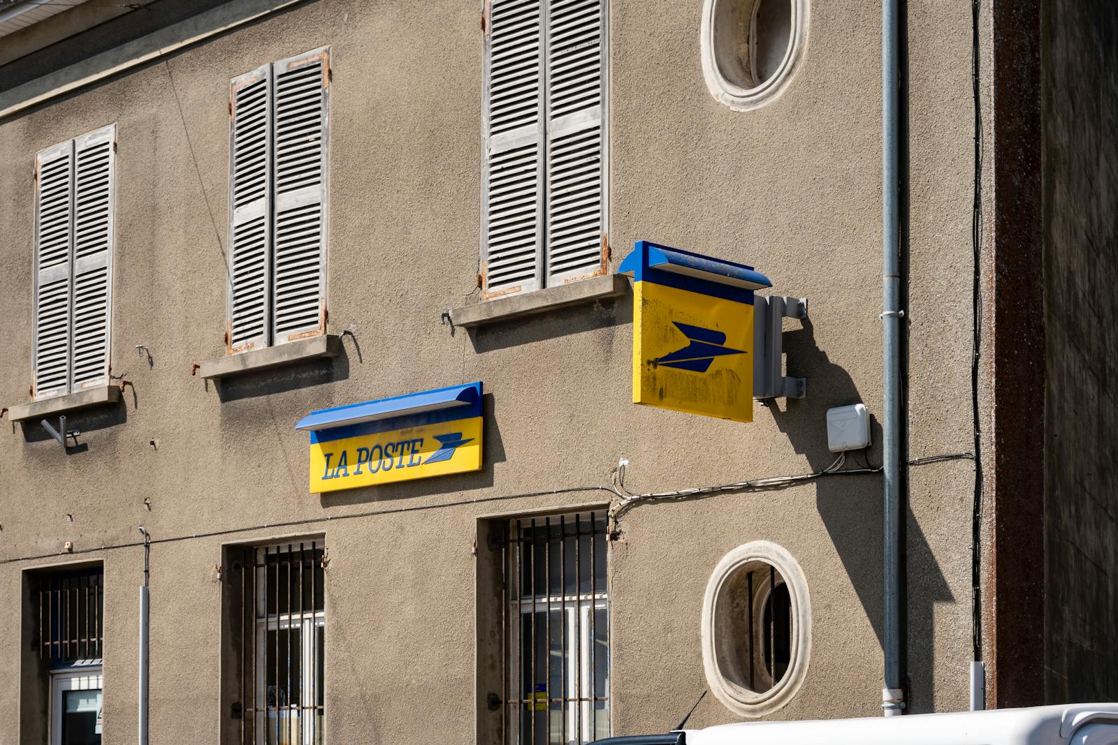 Street view of a La Poste building in France with its iconic signage.